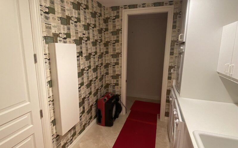 WrightWay red carpet runner extending down a Florida home hallway with plastic containment,