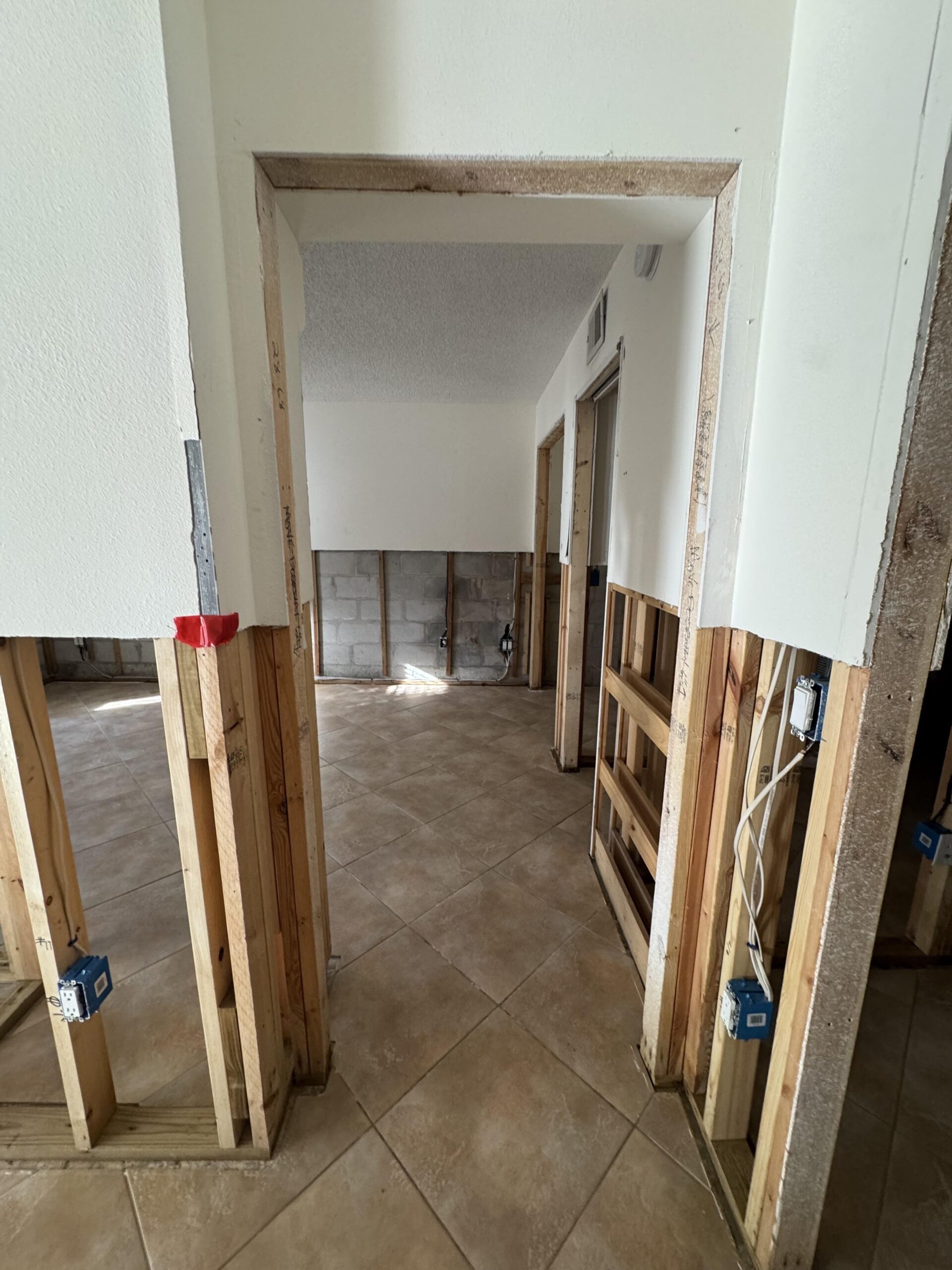 Flood-cut drywall removal during water damage restoration in a Longboat Key condo
